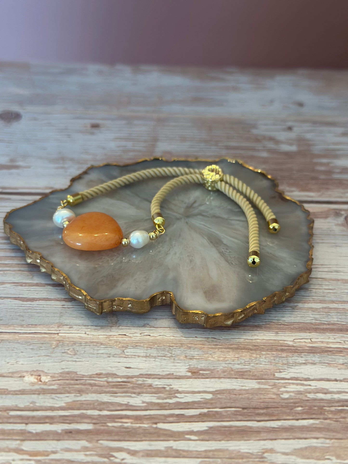 Pulseras en cordón beige con dije de 🧡 Ámbar