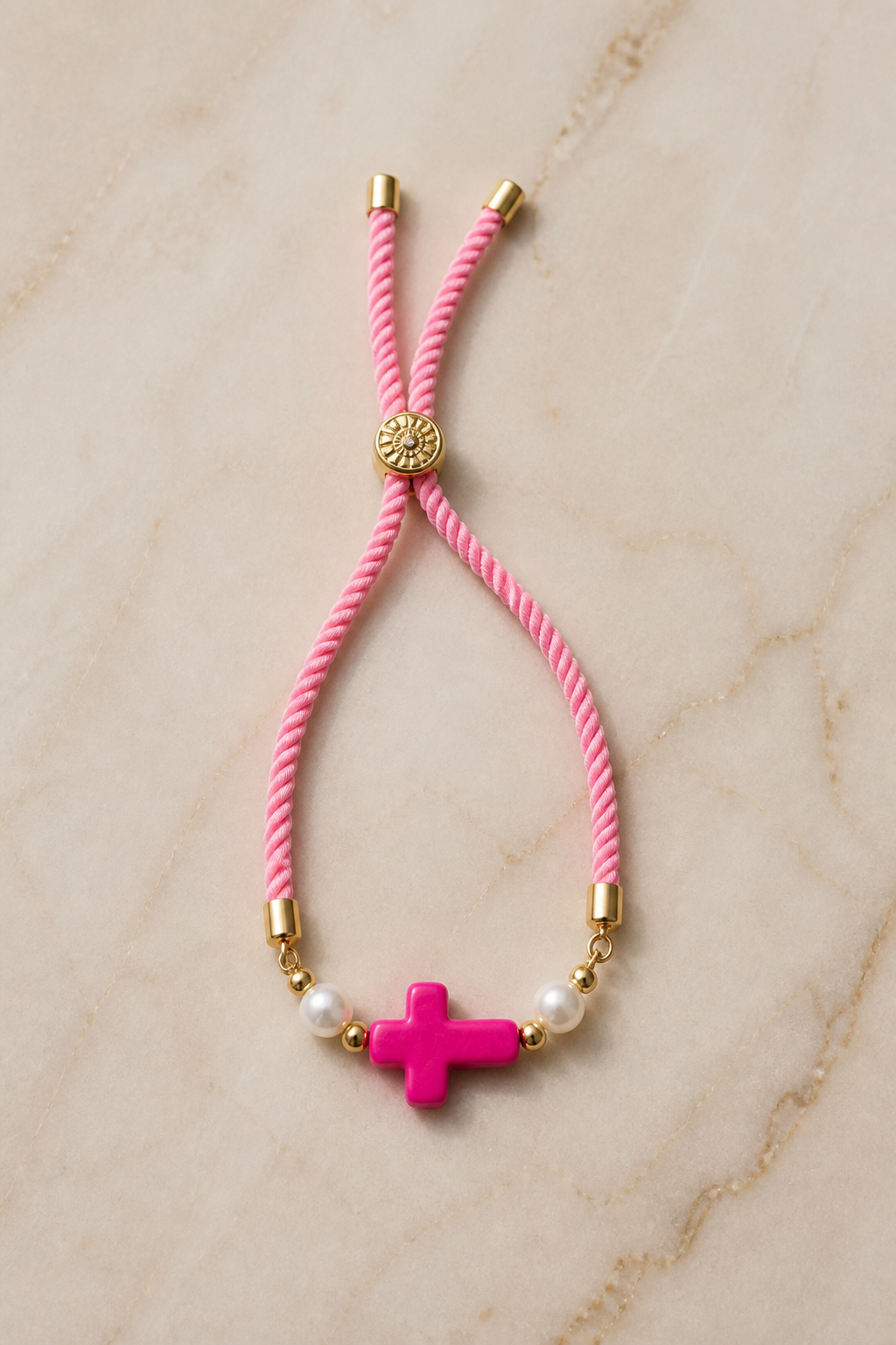 Pulseras en cordón rosado con cruz