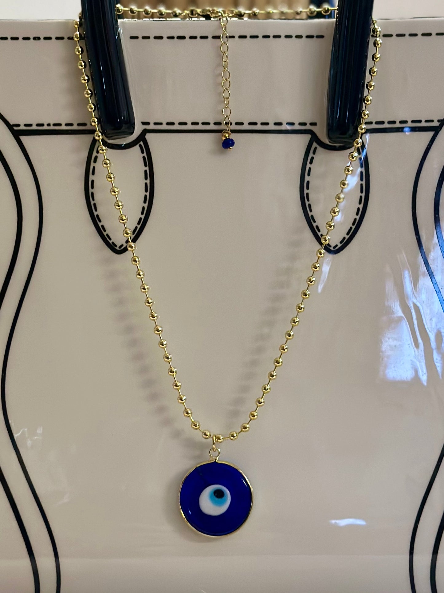 A Cadena estilo militar con baño de oro 18k y dije de Ojo Turco 🧿